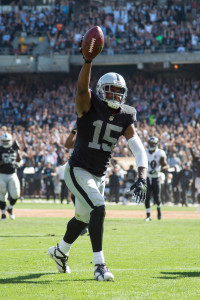 September 20, 2015; Oakland, CA, USA; Oakland Raiders wide receiver Michael Crabtree (15) scores a touchdown against Baltimore Ravens defensive back Kyle Arrington (24, right) during the third quarter at O.co Coliseum. The Raiders defeated the Ravens 37-33. Mandatory Credit: Kyle Terada-USA TODAY Sports