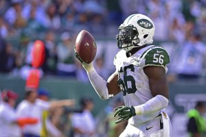 Sep 27, 2015; East Rutherford, NJ, USA; New York Jets inside linebacker Demario Davis (56) comes away with a fumble recovery during the fourth quarter against the Philadelphia Eagles at MetLife Stadium. The Philadelphia Eagles defeated the New York Jets 24-17. Mandatory Credit: Steven Ryan-USA TODAY Sports