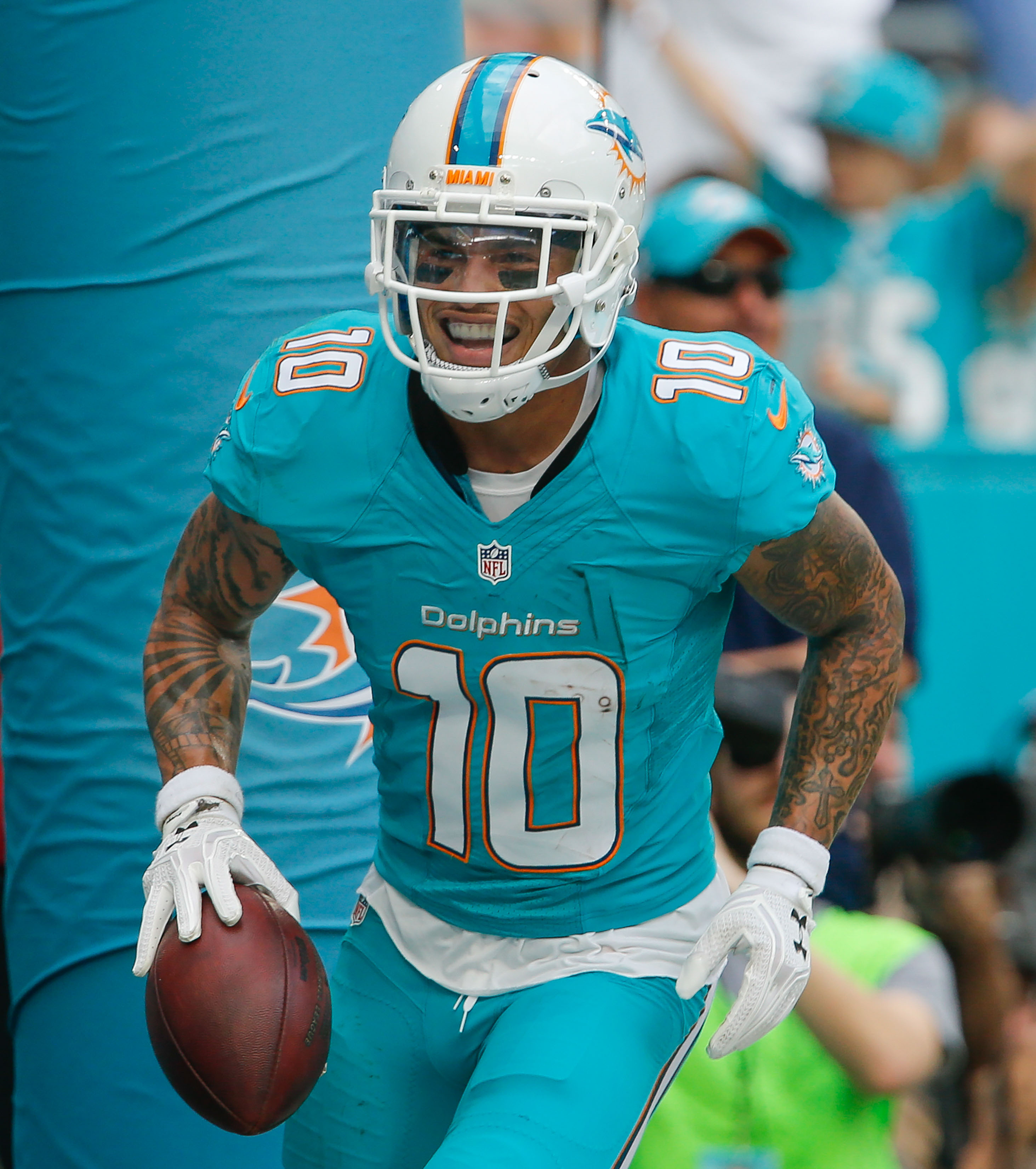 Miami Dolphins wide receiver Kenny Stills adjusts his helmet in the rain  during an NFL football practice, Monday, June 5, 2017, at the Dolphins  training facility in Davie, Fla. (AP Photo/Wilfredo Lee