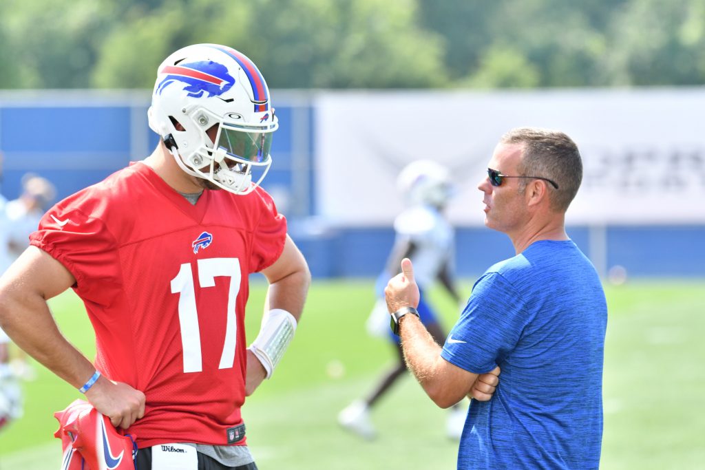 Buffalo Bills' Jerry Hughes gets his helmet stuck on teammate's jersey