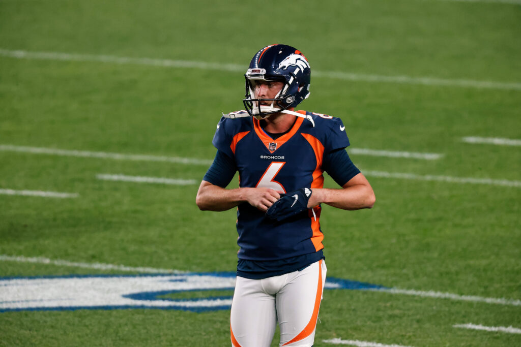 Denver Broncos punter Corliss Waitman (17) punts against the Los